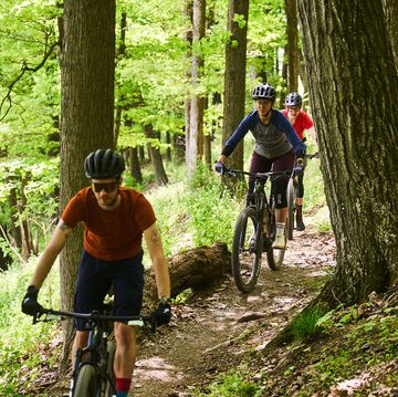 group of cyclists riding mountain bikes on a trail in trexlertown