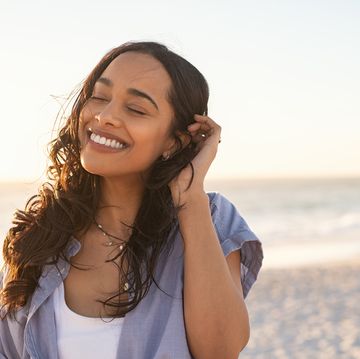 carefree beautiful latin woman relaxing on beach