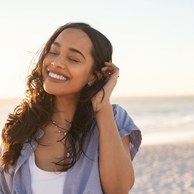 carefree beautiful latin woman relaxing on beach