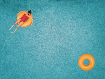 carefree woman on ring in swimming pool