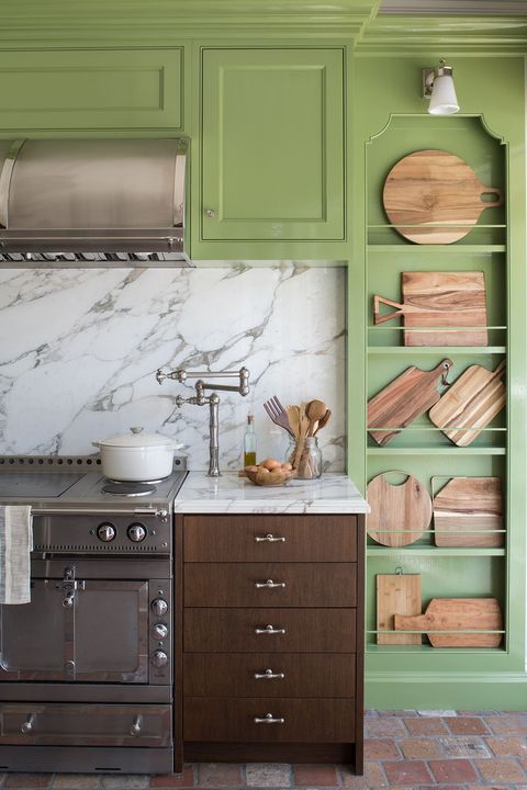 green kitchen with wood cabinets and wood cutting board decor