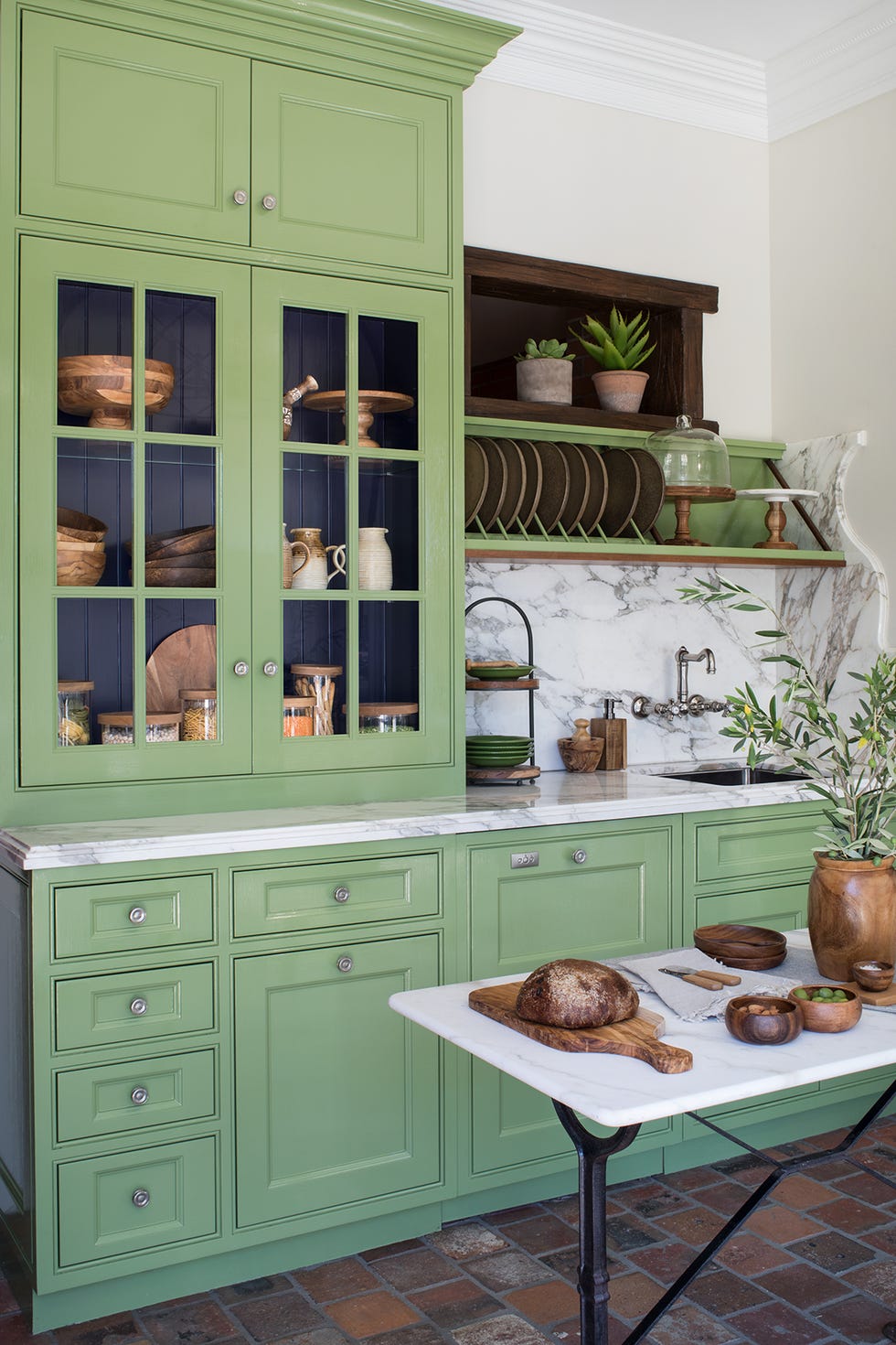 a green cabinet with a table and plants on it