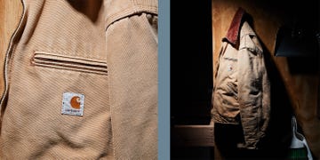 carhartt jacket hanging on a wooden backdrop