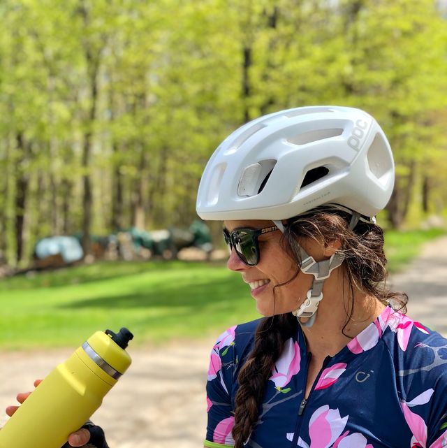 carina hamel wearing a helmet and holding a yellow bottle