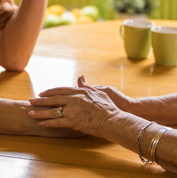 Caring senior woman comforting her worried husband, holding his hand caring senior woman comforting her worried husband, holding his hand