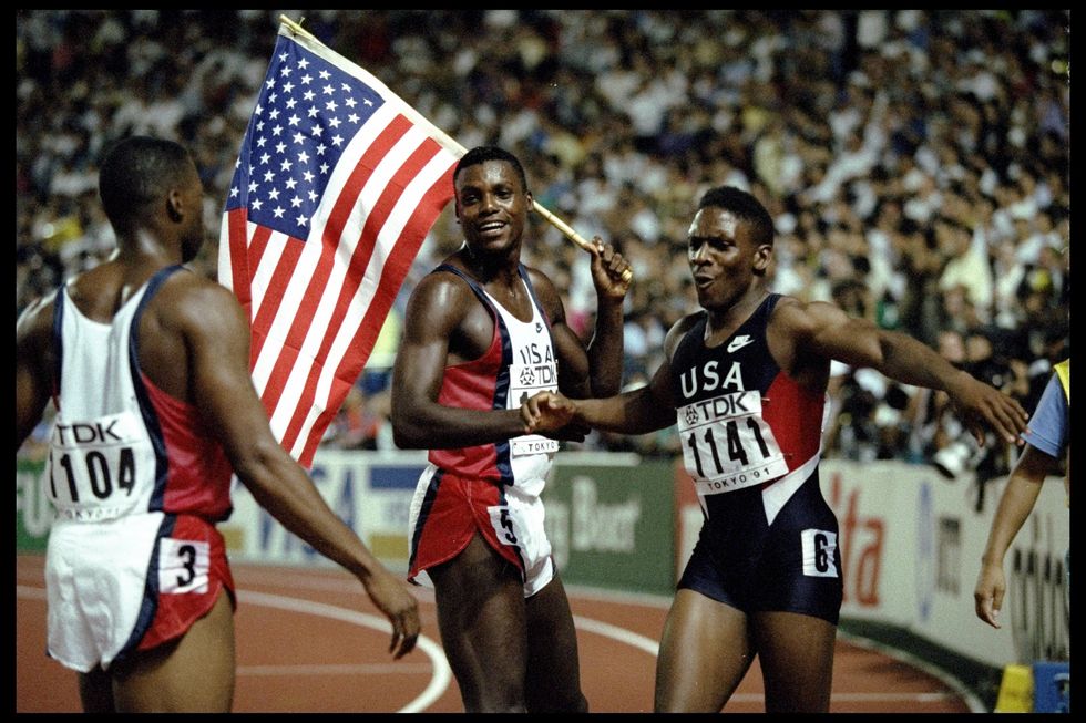 Carl Lewis of the USA (centre) celebrates after winning the 100 metres