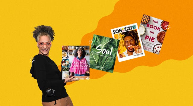 carla hall holding an array of soul food cookbooks