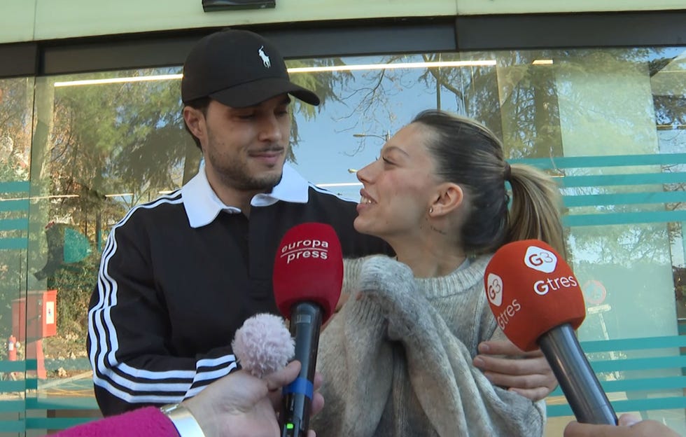 individuals being interviewed outside a building