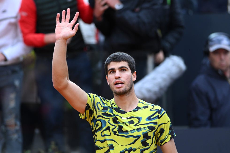 carlos alcaraz celebrates winning a tennis match