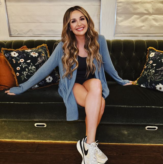 carly pearce smiling sitting on tufted green velvet couch on her bus, processed with vsco with av4 preset