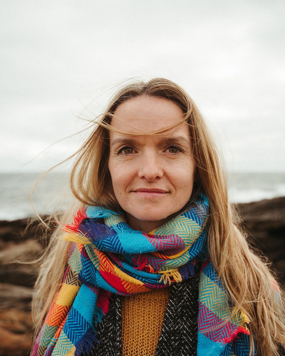 a woman with long hair wearing a colorful scarf