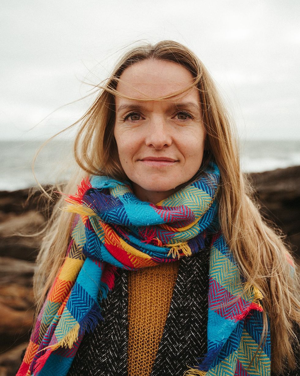 a woman with long hair wearing a colorful scarf