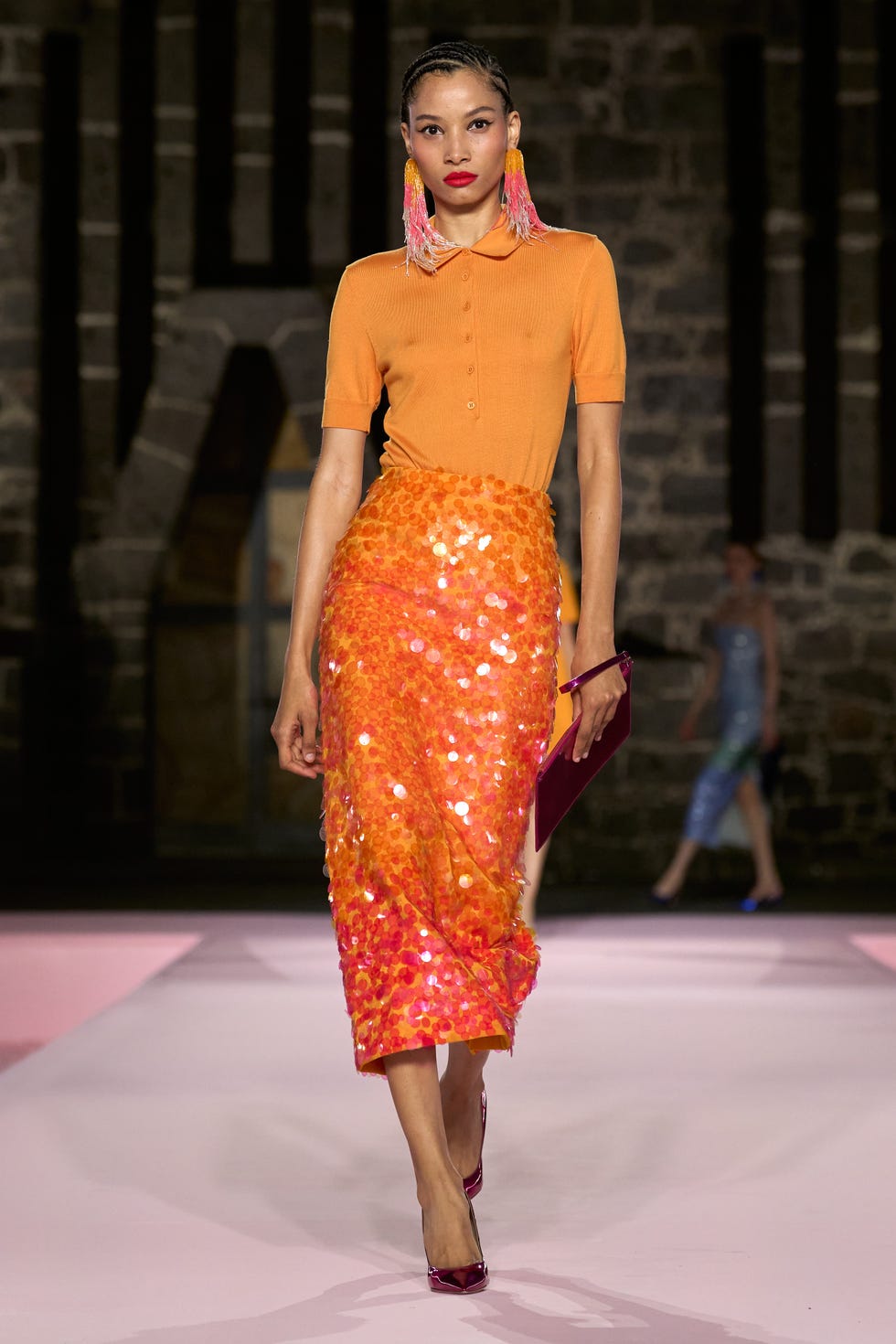 model showcasing a vibrant outfit on a runway