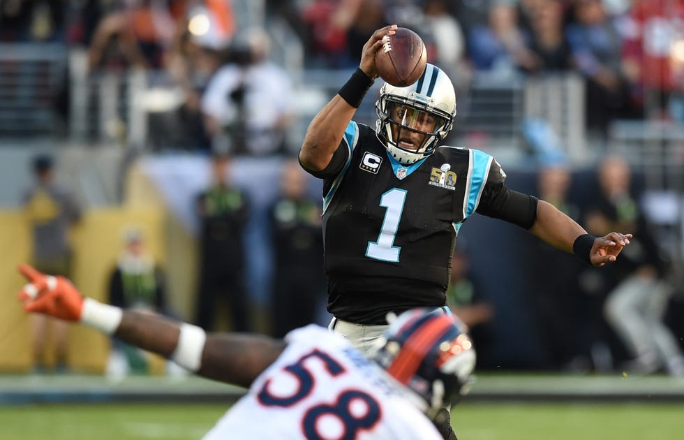 carolina panthers quarterback cam newton running forward with the football while denver broncos player von miller attempts to tackle him during super bowl 50