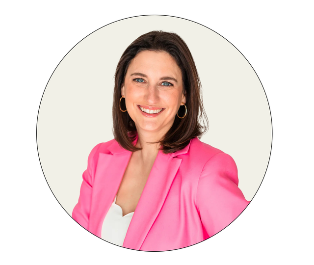 professional portrait featuring a woman in a bright pink blazer