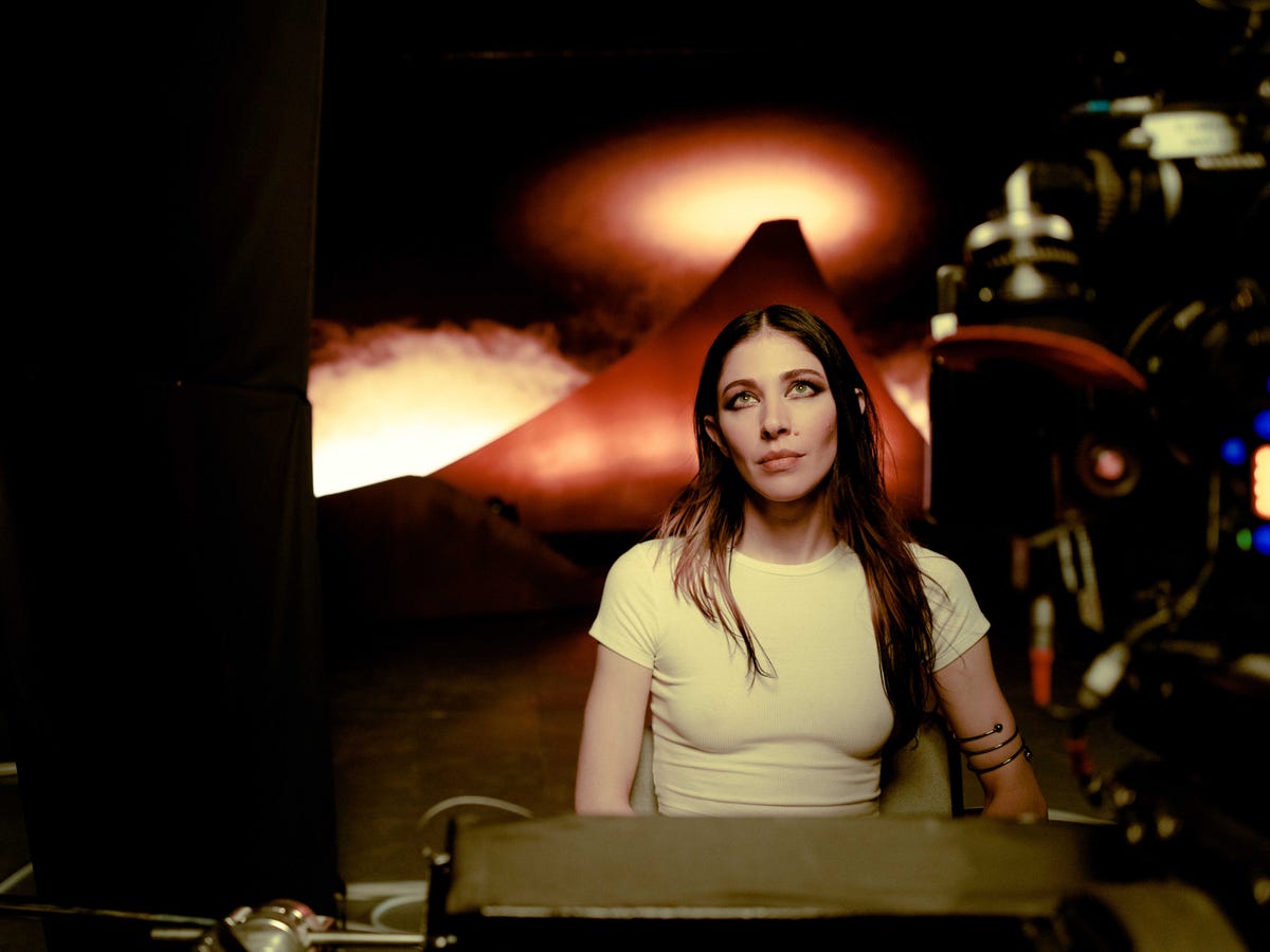 caroline polachek seated on the set of her smoke video