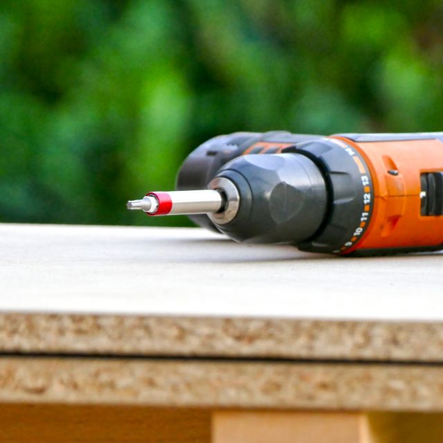 Carpenter's battery drill is lying on the construction site