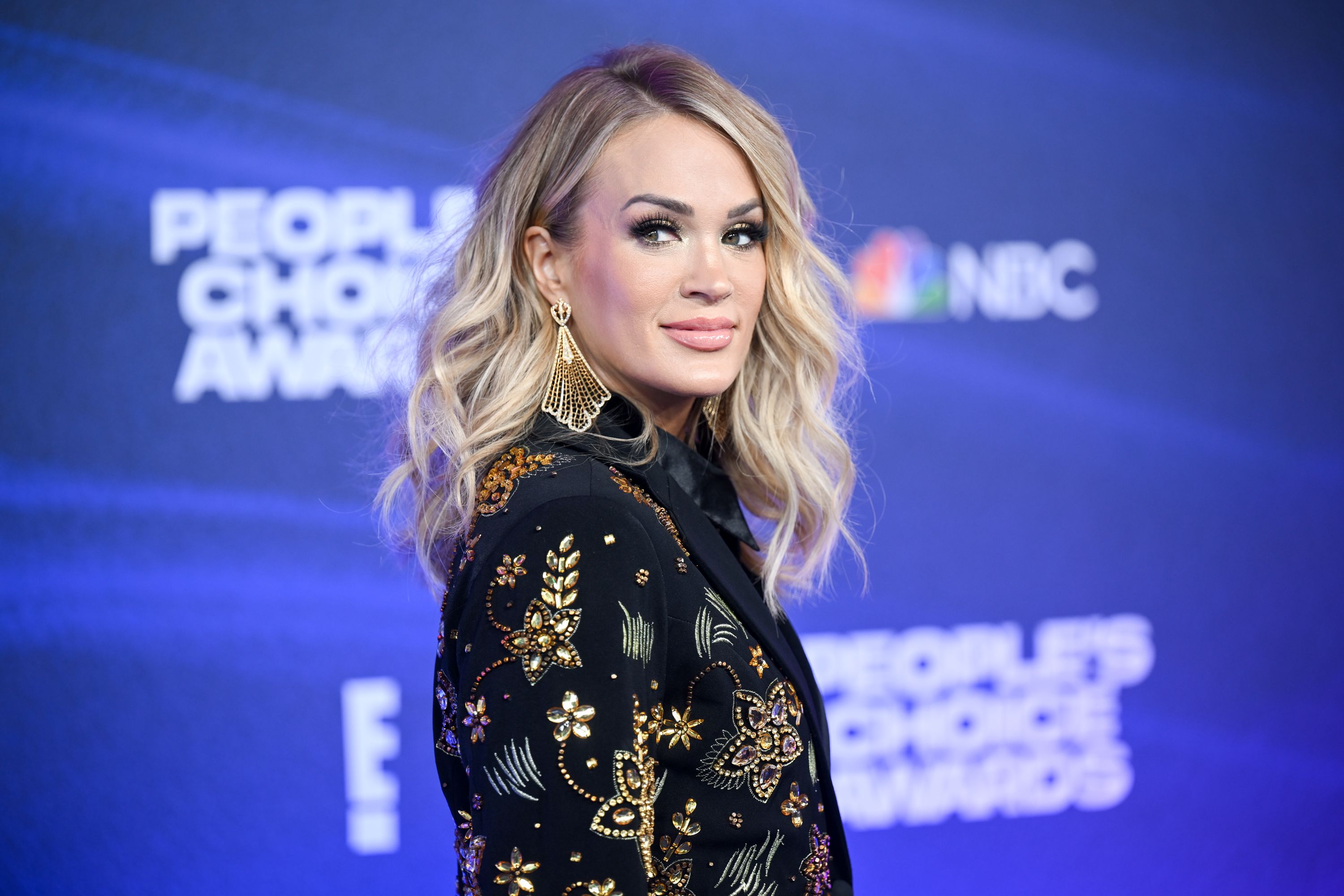 Carrie Underwood Surprises Fans in a Glowing Muscle Tee, Royal Blue Leggings  & Her Go-To Sneakers