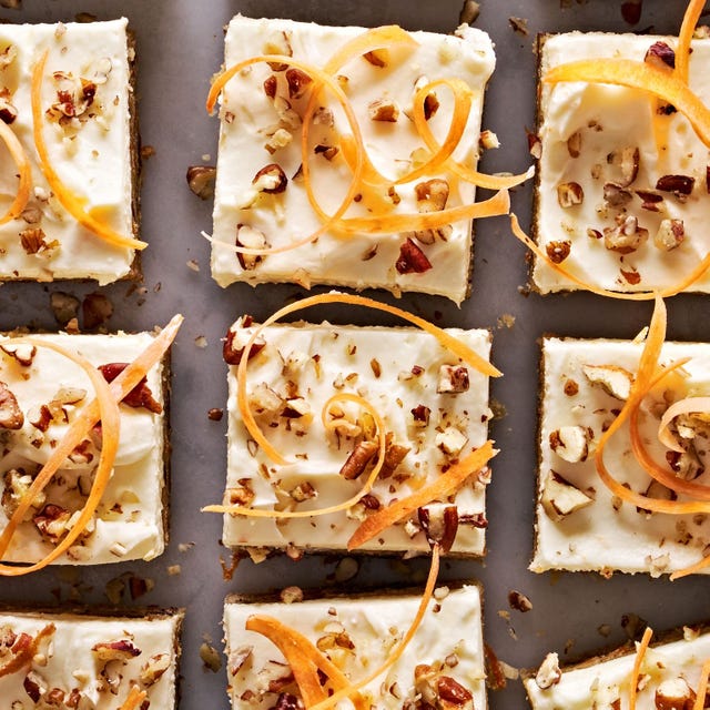 carrot cake blondies topped with pecans and carrot ribbons