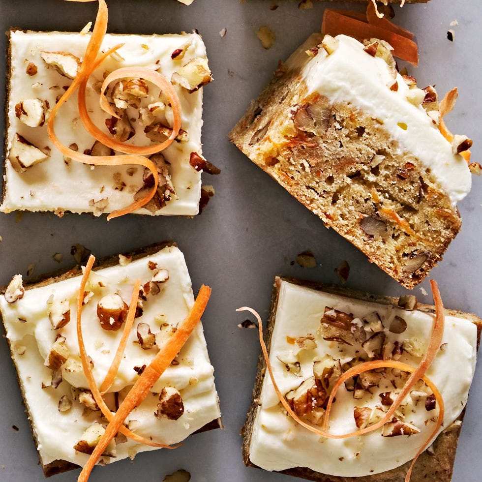 carrot cake blondies topped with pecans and carrot ribbons