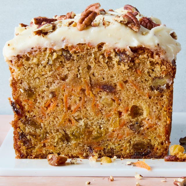 Carrot Cake Bread carrot cake loaf with cream cheese frosting and chopped nuts