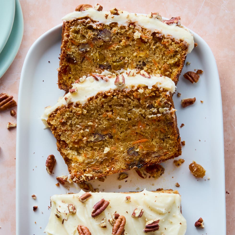 carrot cake loaf with cream cheese frosting and chopped nuts