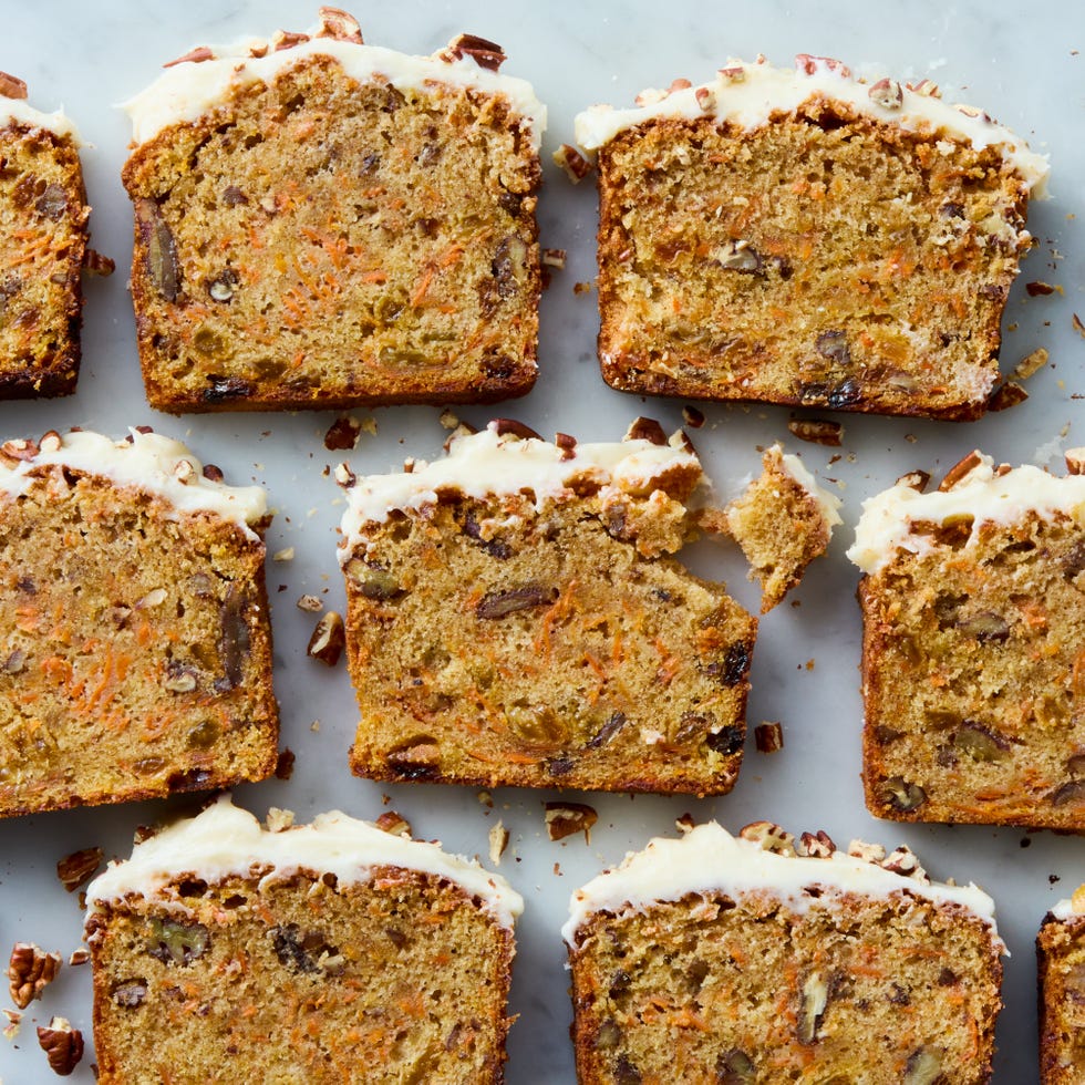 carrot cake loaf with cream cheese frosting and chopped nuts