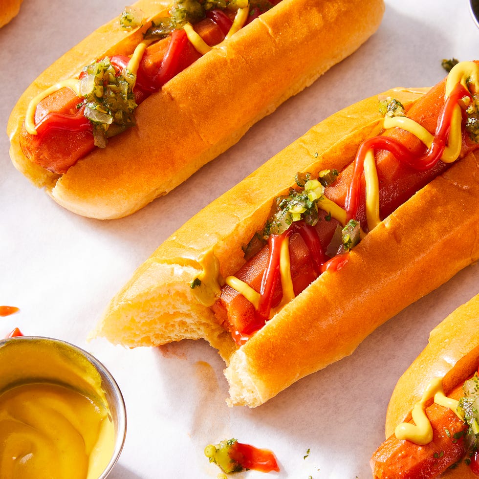 carrots in a hotdog bun with mustard, ketchup, and relish