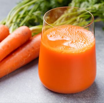 Carrot juice in glass and fresh carrots Healthy food