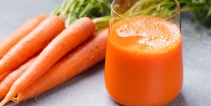 Carrot juice in glass and fresh carrots Healthy food