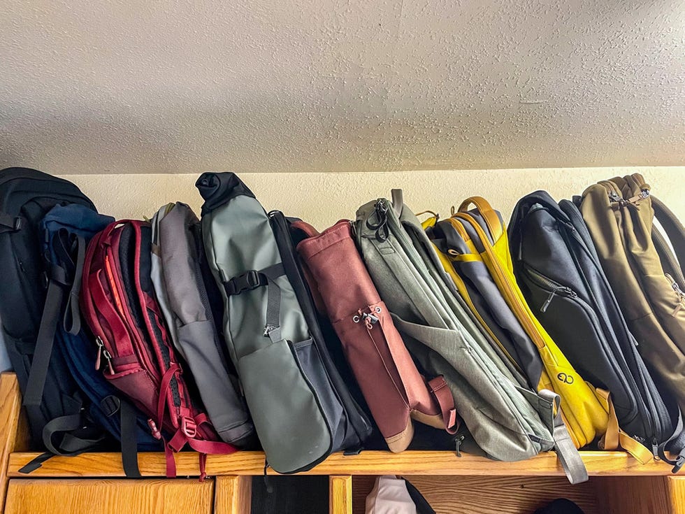 a group of backpacks on a shelf