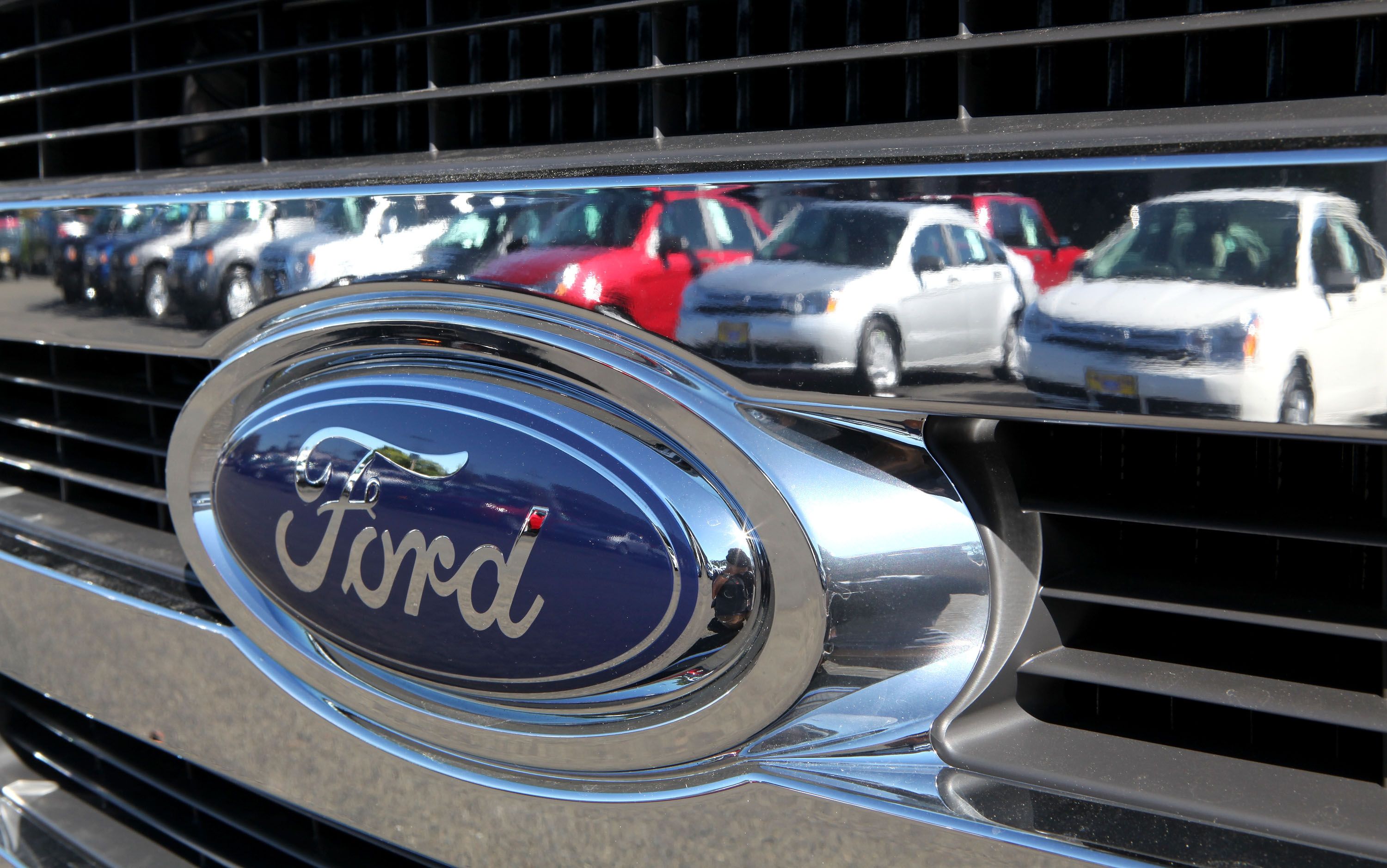 https://hips.hearstapps.com/hmg-prod/images/cars-are-reflected-in-the-grill-of-a-new-ford-truck-news-photo-1626719456.jpg