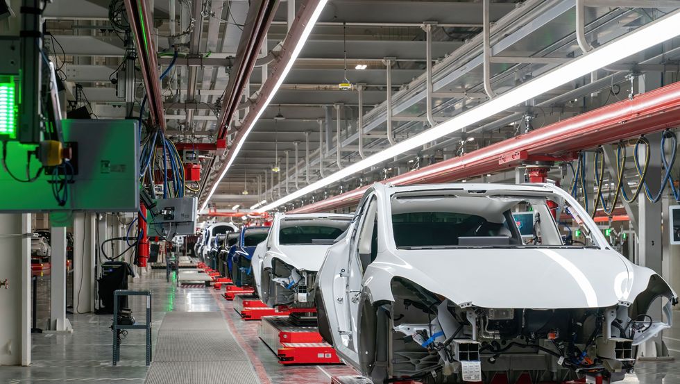 tesla giga texas factory with model y bodies on assembly line