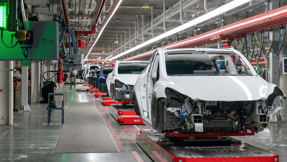 tesla giga texas factory with model y bodies on assembly line