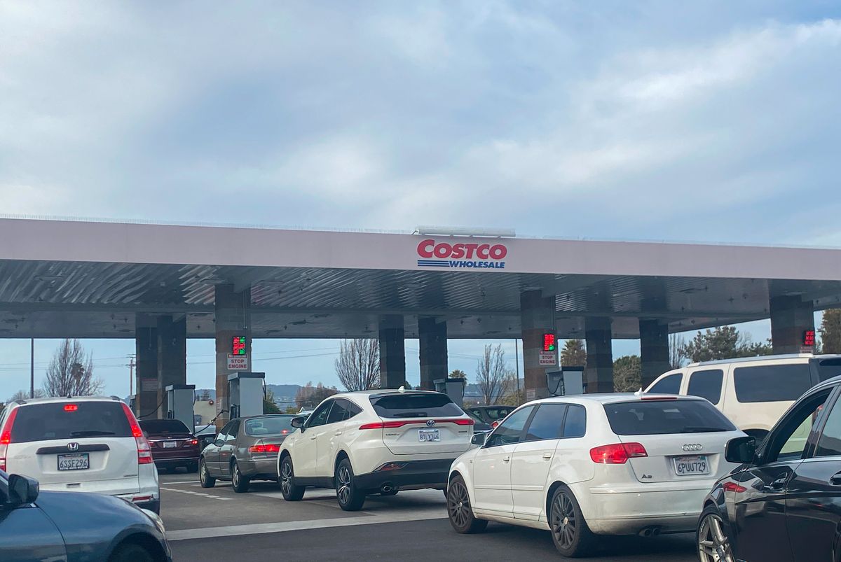 cars are waiting to pump gas at a costco gas station