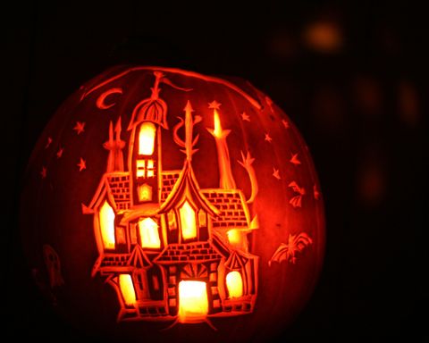 carved pumpkin with haunted house