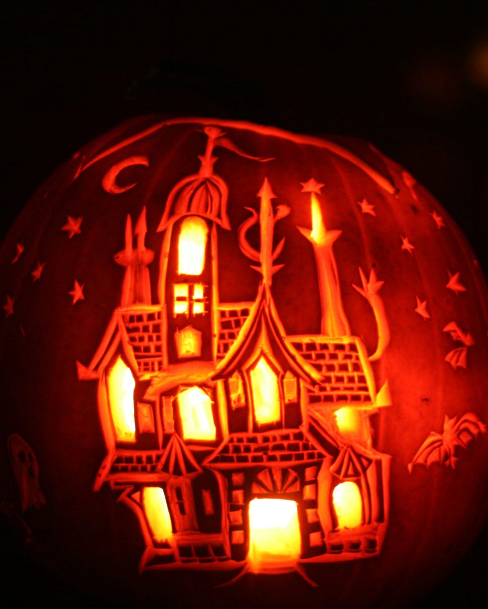 carved pumpkin with haunted house