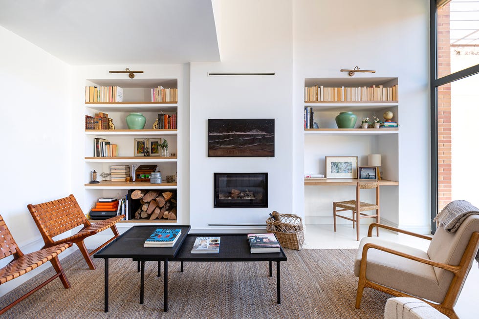 salón con chimenea y estantería de obra