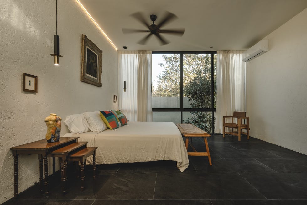 casa de hormigon, estrecha y alargada, que resuelve la distribucion en dos volumenes conectados por un patio