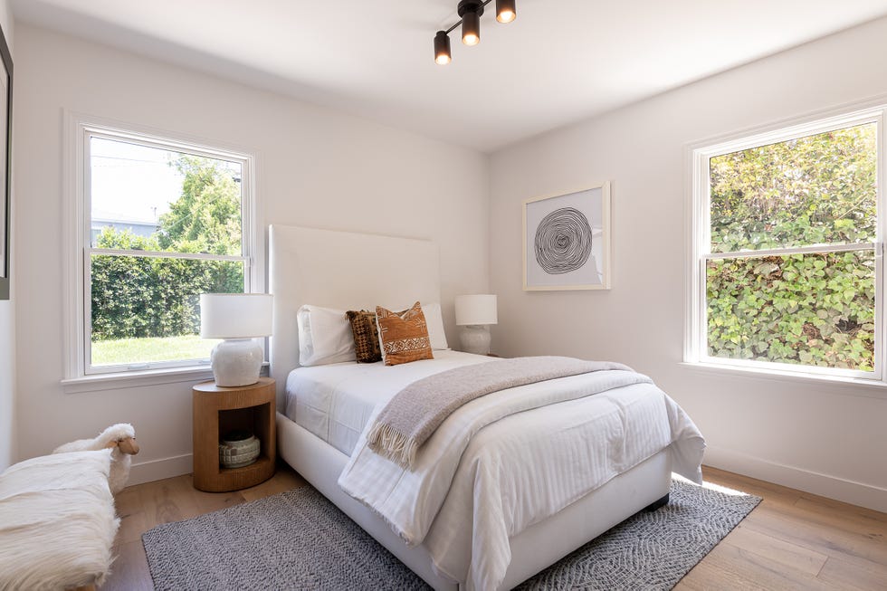dormitorio con cama y cabecero tapizados en beige