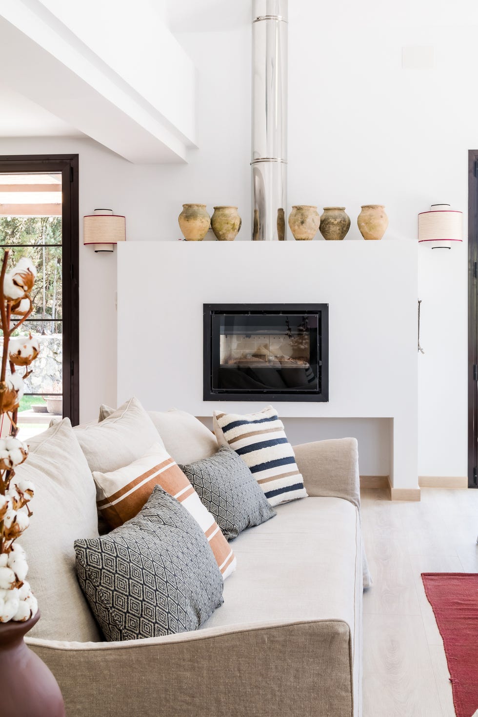 salón con chimenea empotrada y sofá de lino