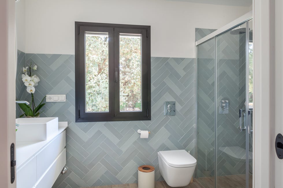baño con azulejos en espiga azules