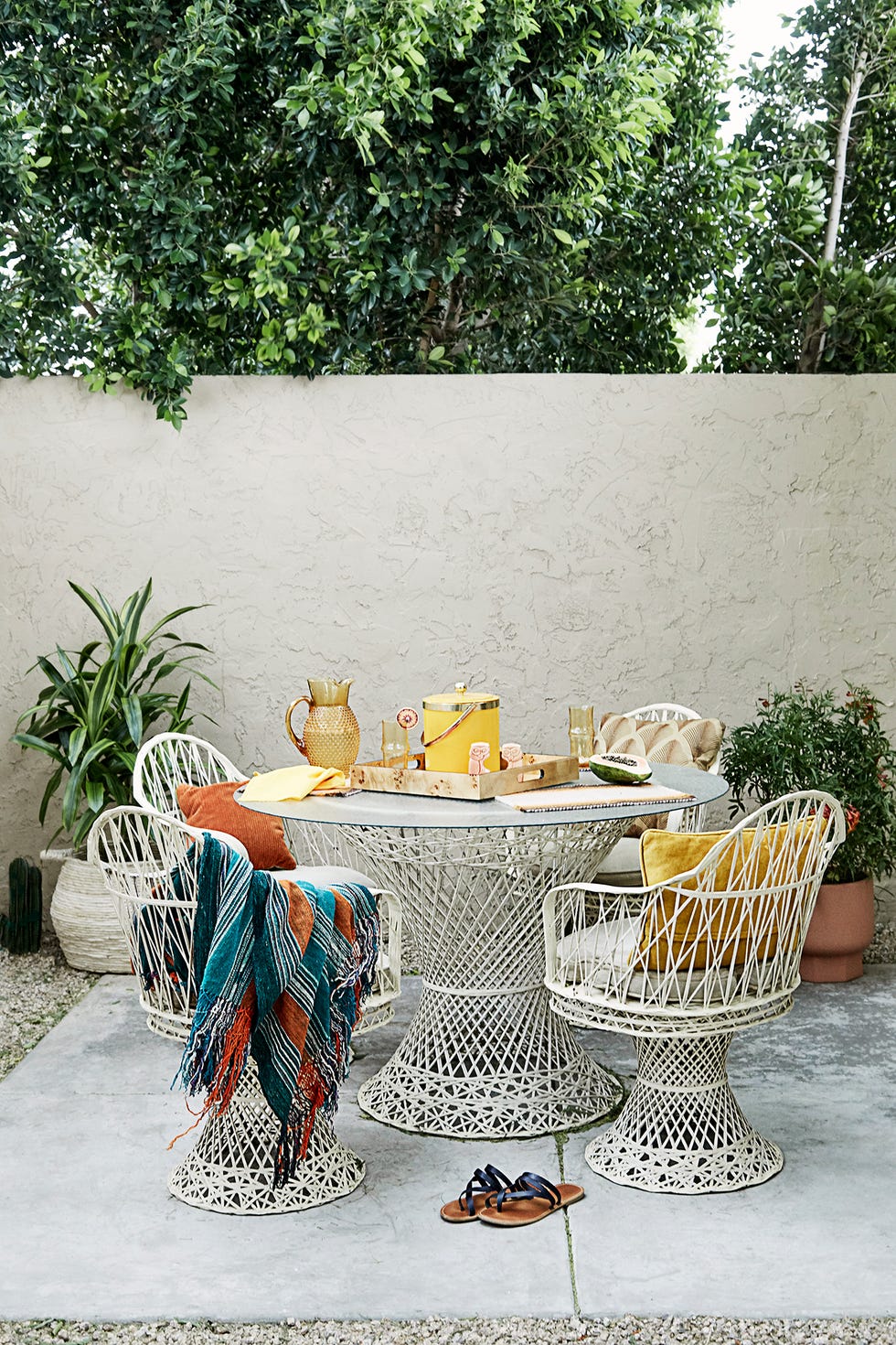 pequeño comedor con mesa y sillas trenzadas al aire libre