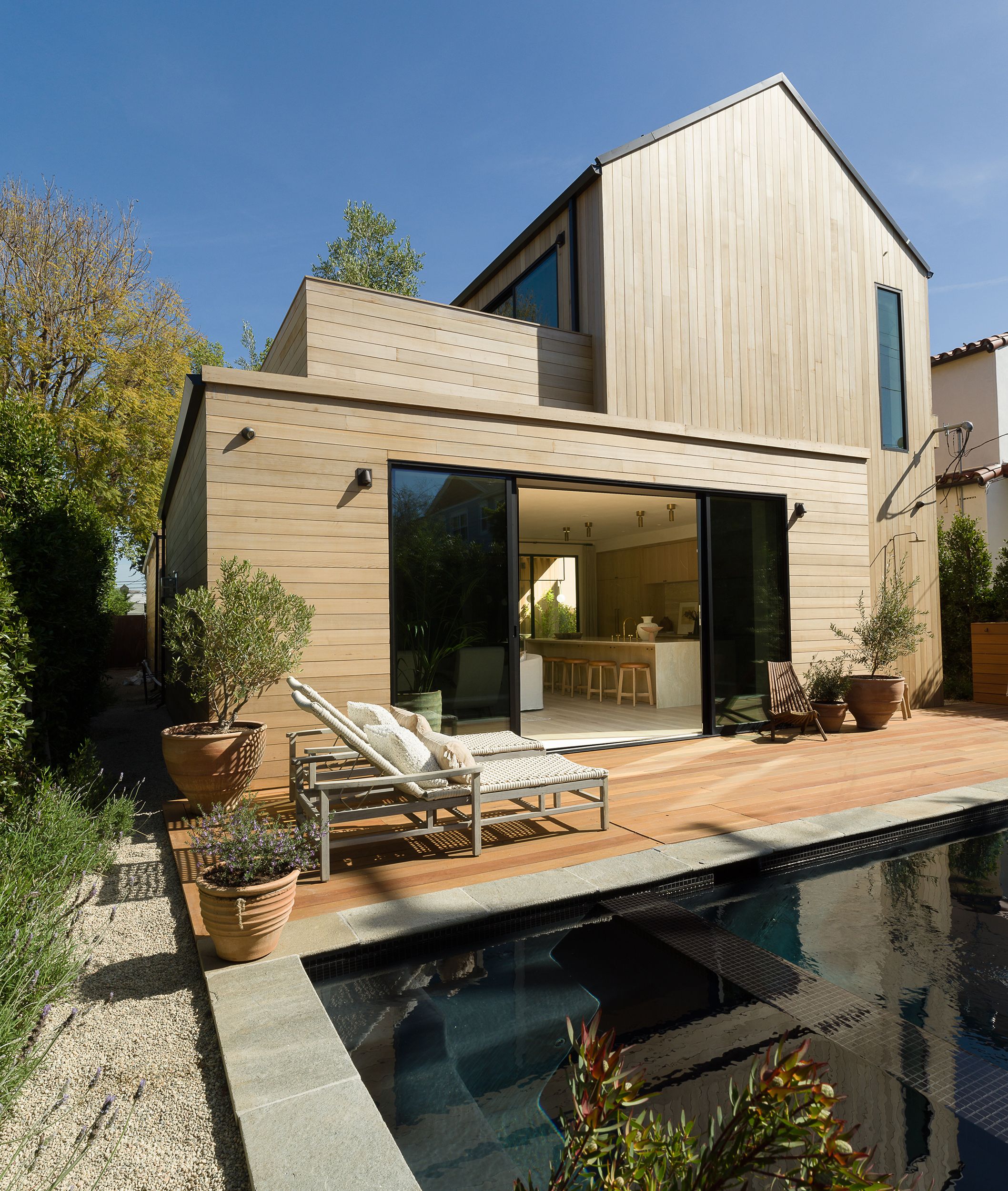 Una casa de madera de diseño moderno con piscina y porche, casa de