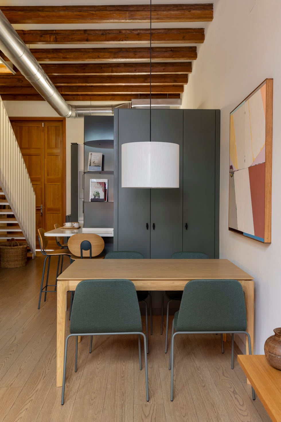 cocina y comedor abiertos con muebles en verde oliva
