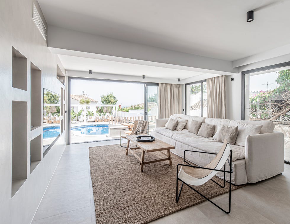 salón escandinavo y boho con sofá de lino blanco y paredes de microcemento