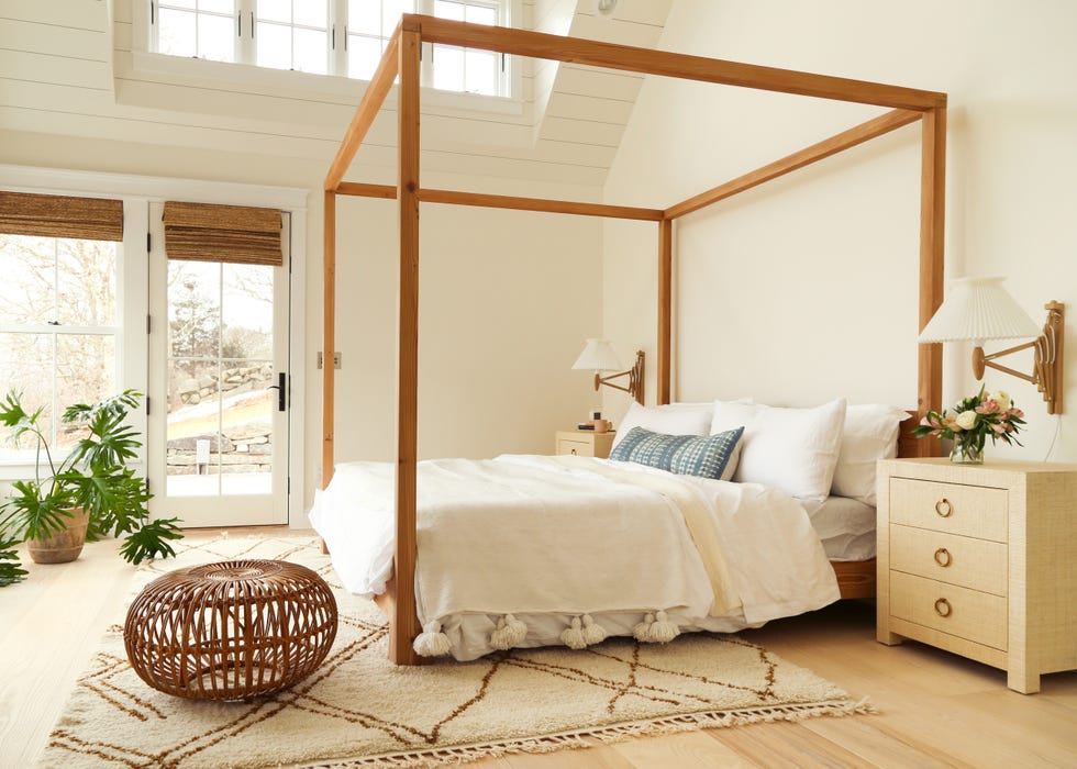 dormitorio de estilo boho y cama con dosel de madera