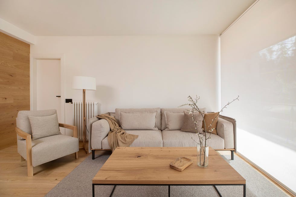 salón con sofá y butaca beige y mesa de centro de madera