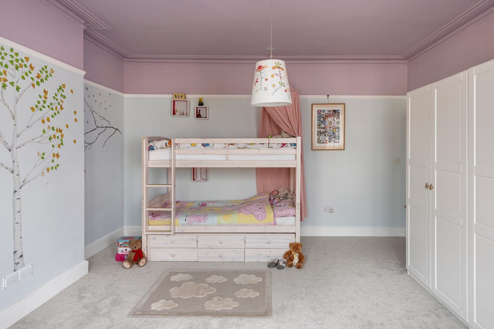 dormitorio infantil con litera y mural con dibujos de árboles en la pared