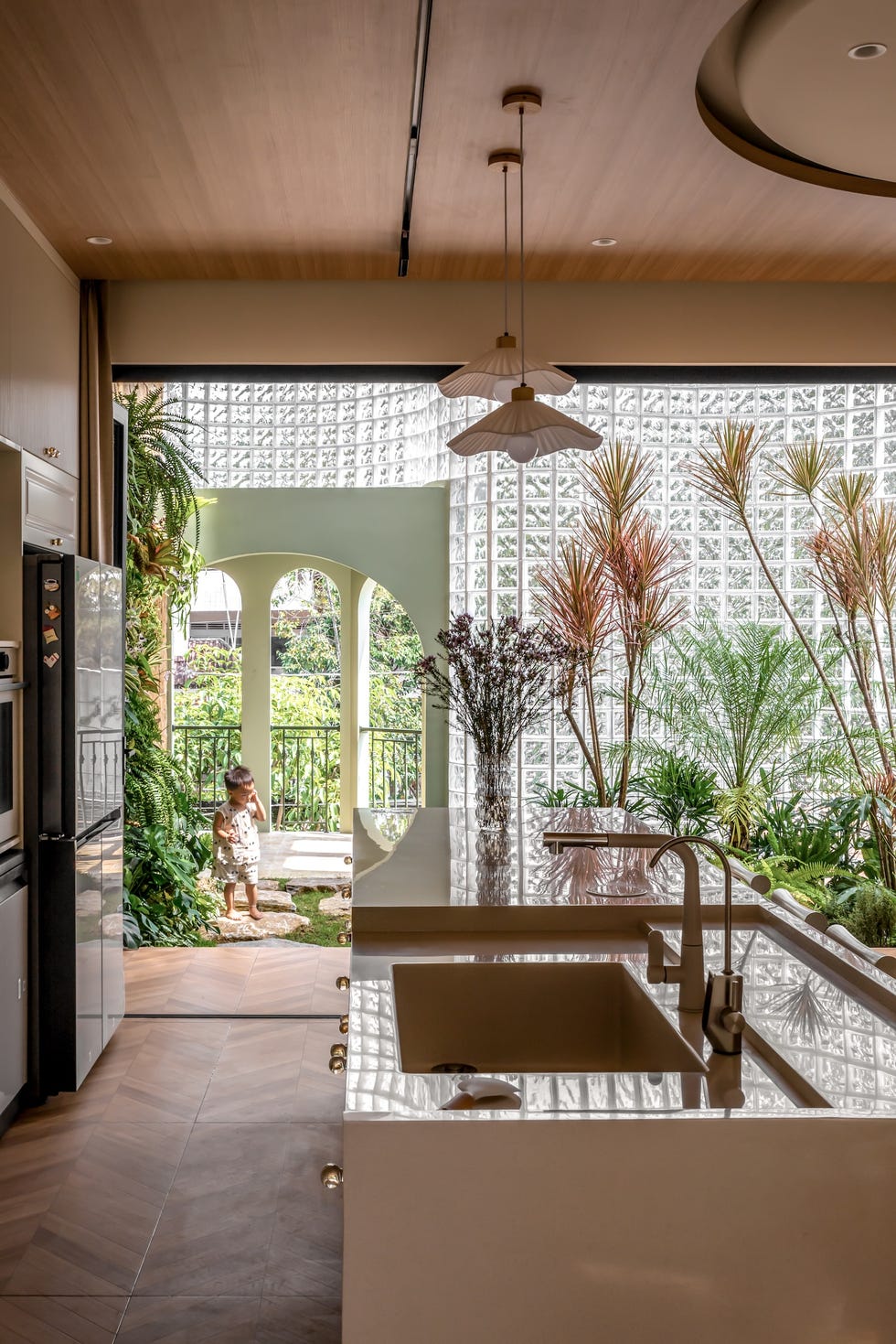 casa de 465 metros con fachada de ladrillo de vidrio, jardines interiores y soluciones pasivas